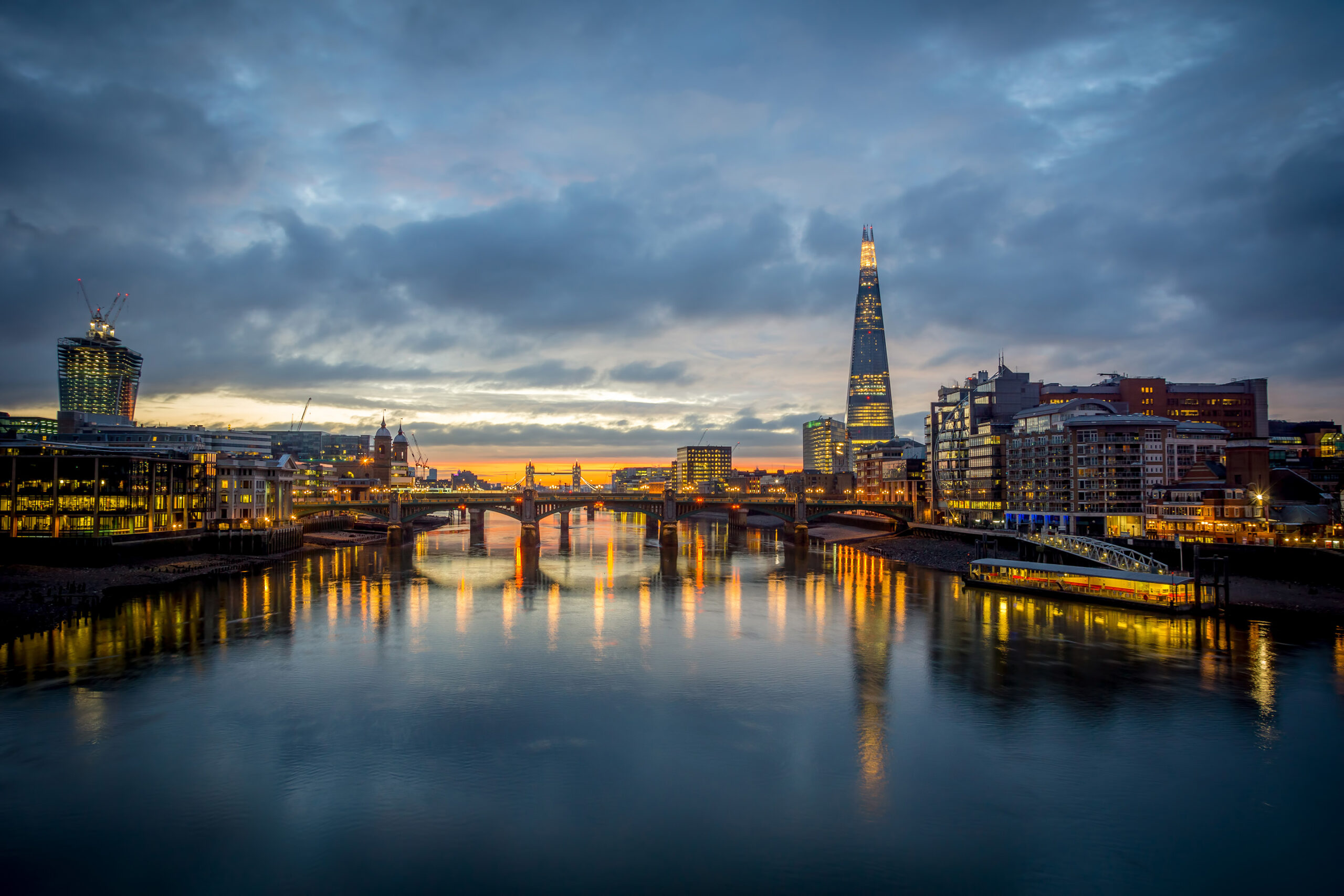 Cityscape at the blue hour with a river going through the middle.